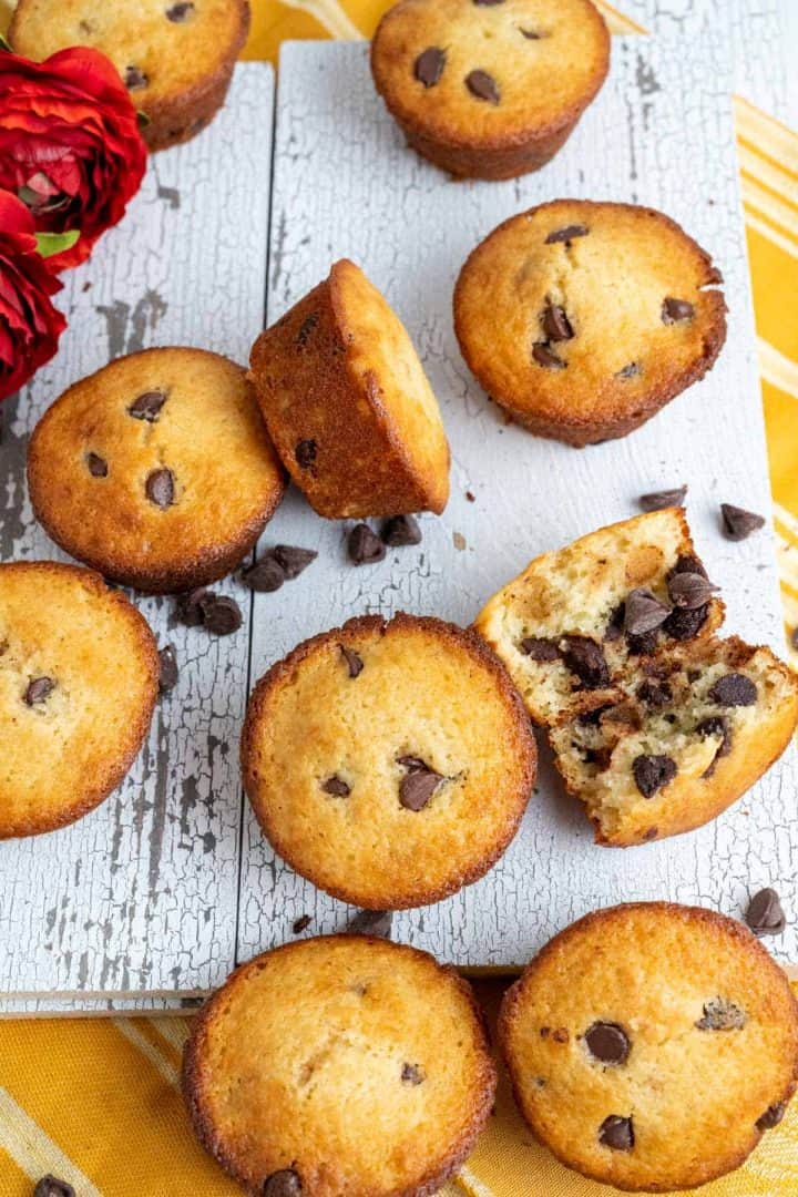 Scattered chocolate muffins on white tray.