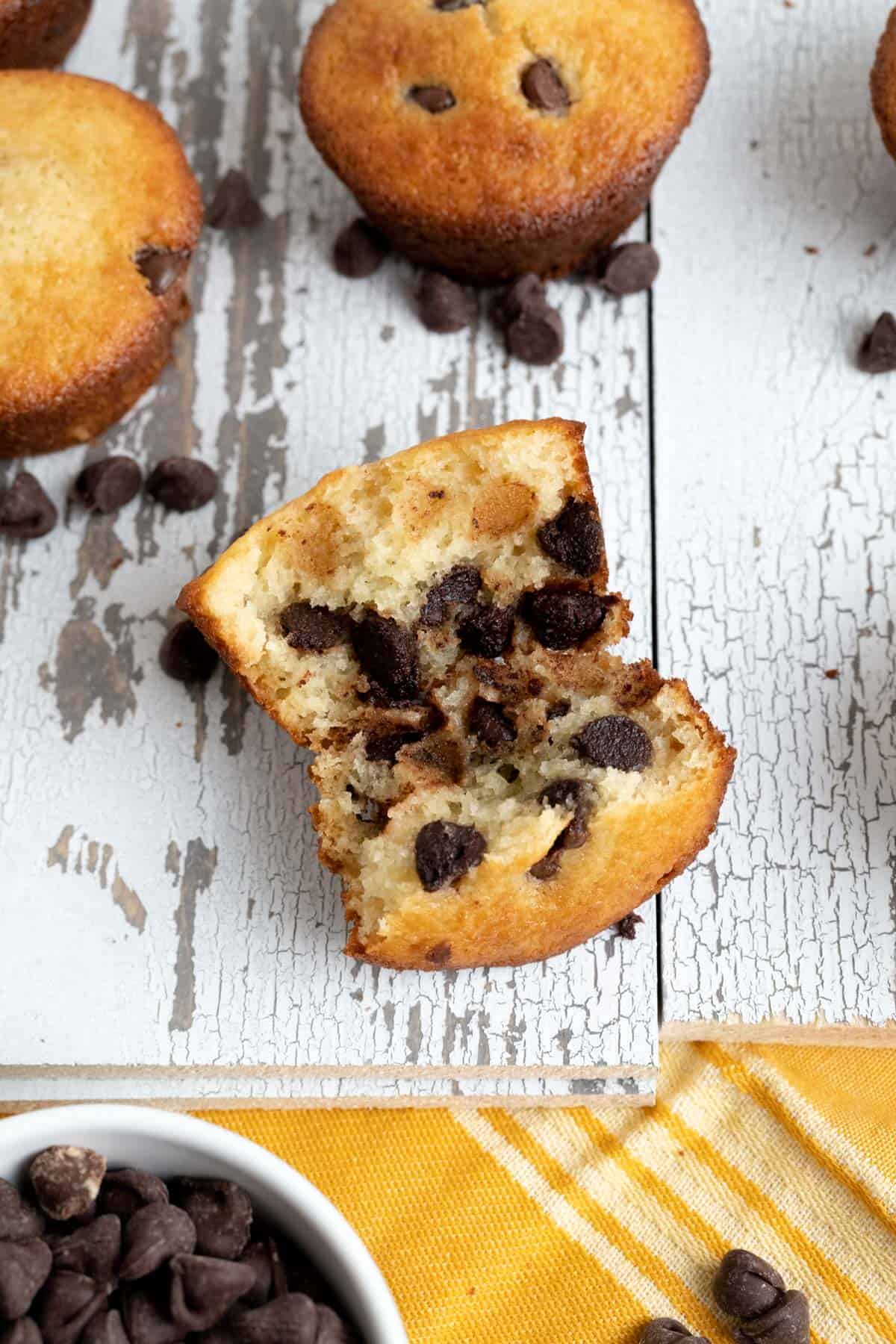 Chocolate chip muffin cut in half showcasing the texture of the muffin.