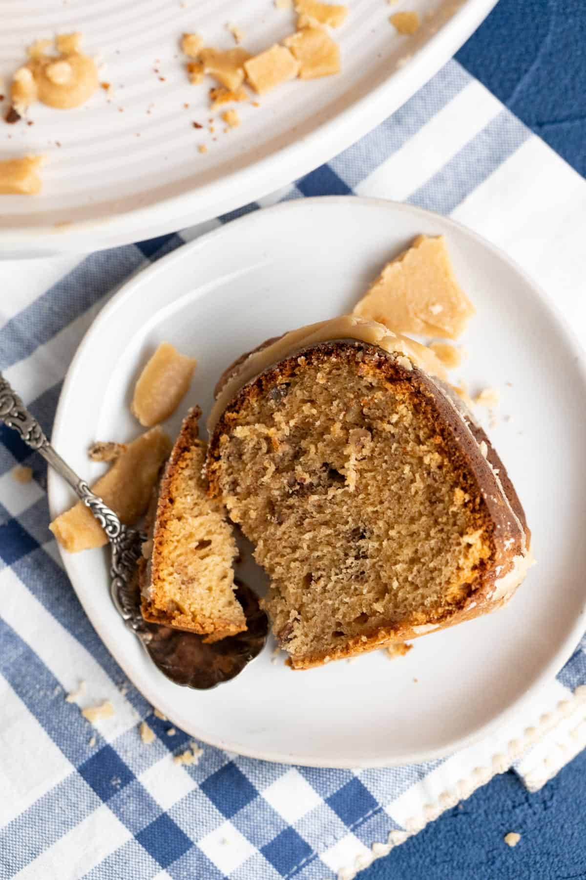 Overhead shot of the pecan praline cake sitting on a white plate.