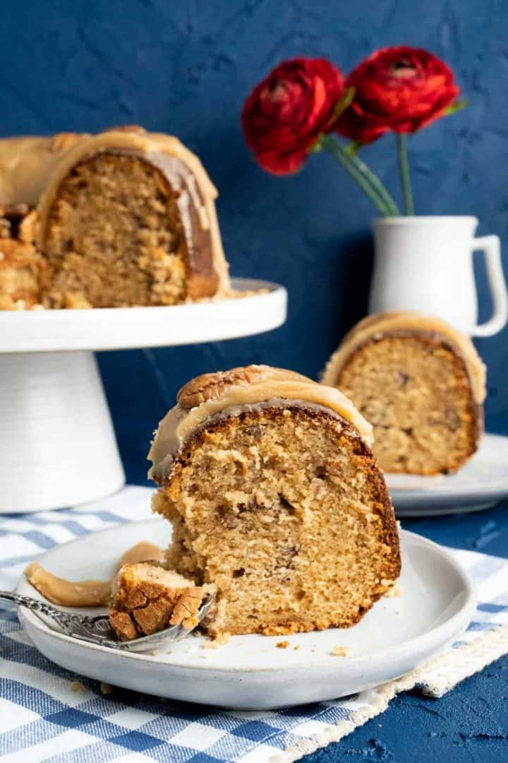 Single slice of praline cake in a small white plate.