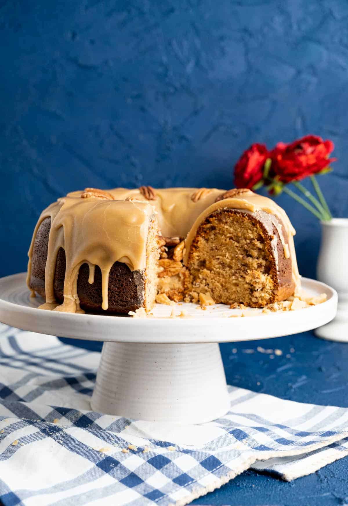 Close shot of cut cake sitting on a cake plate showing the texture of the cake. 