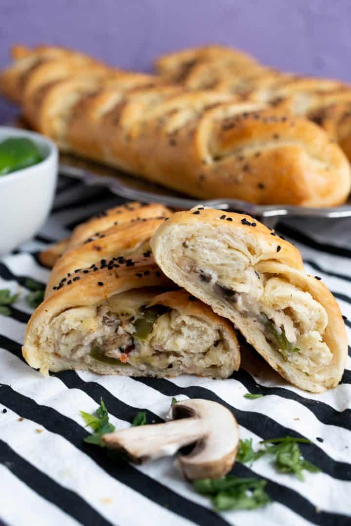 chicken bread cut in half sitting on a black and white table cloth.