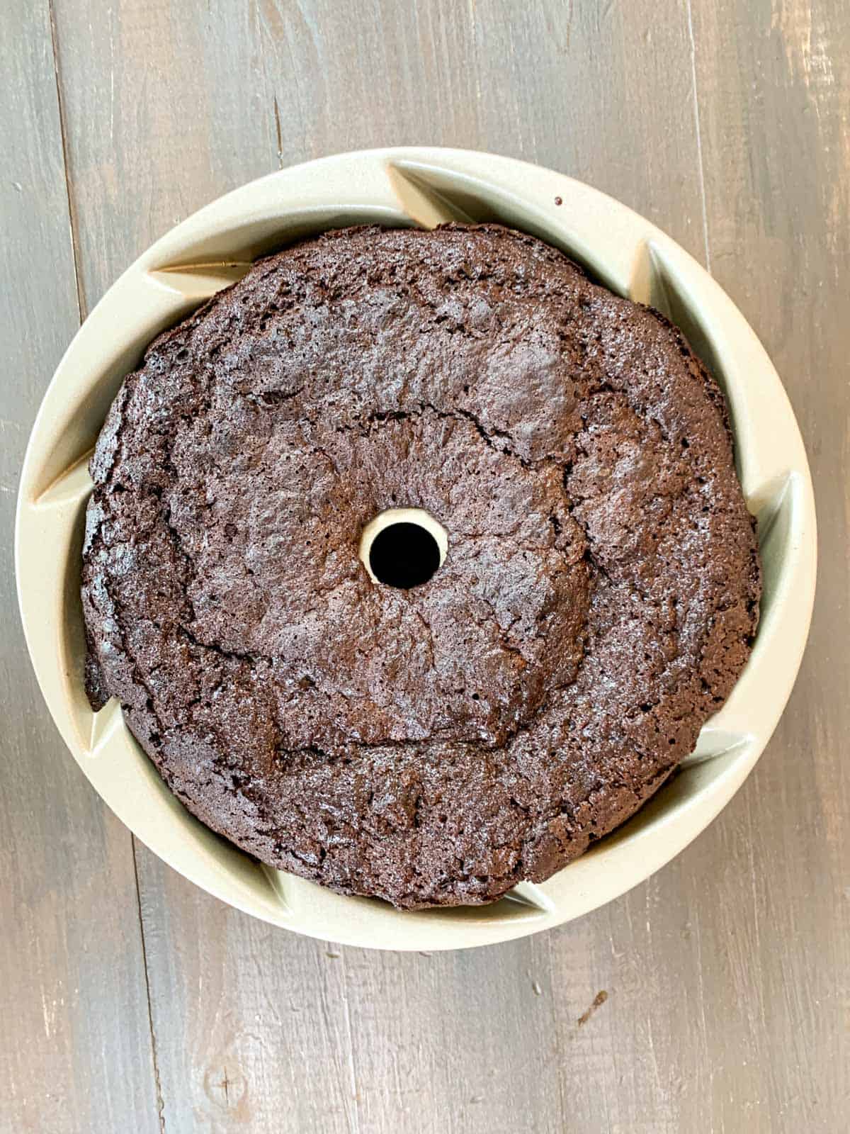 chocolate cake out of the oven sitting in the bundt pan.