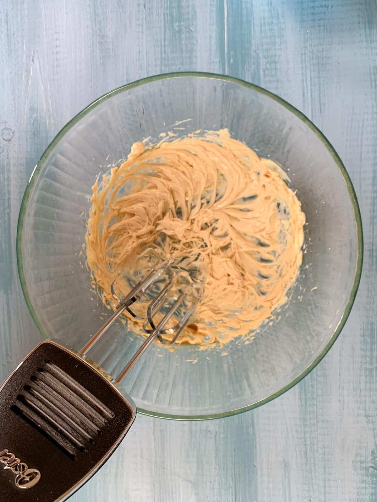 beating the butter and vanilla in a large bowl for butter cream frosting.