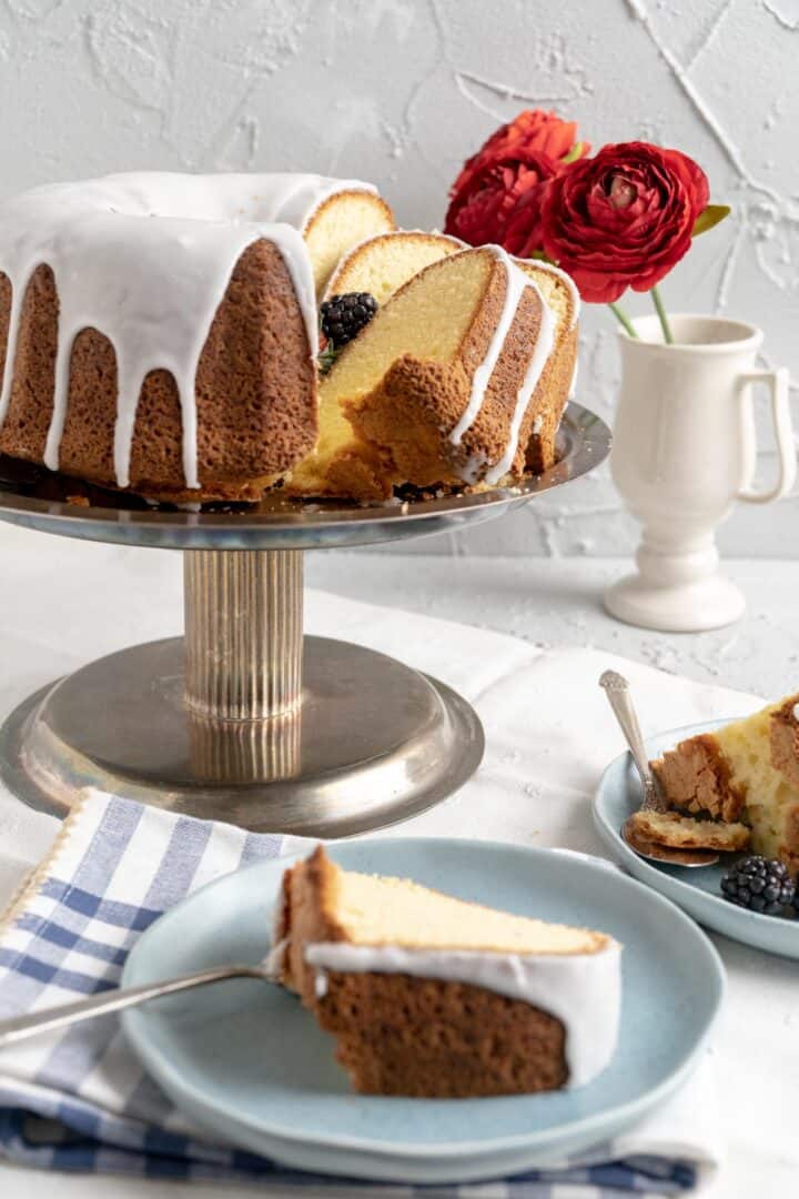 slice of old-fashioned sour cream pound cake on a small blue ceramic plate.