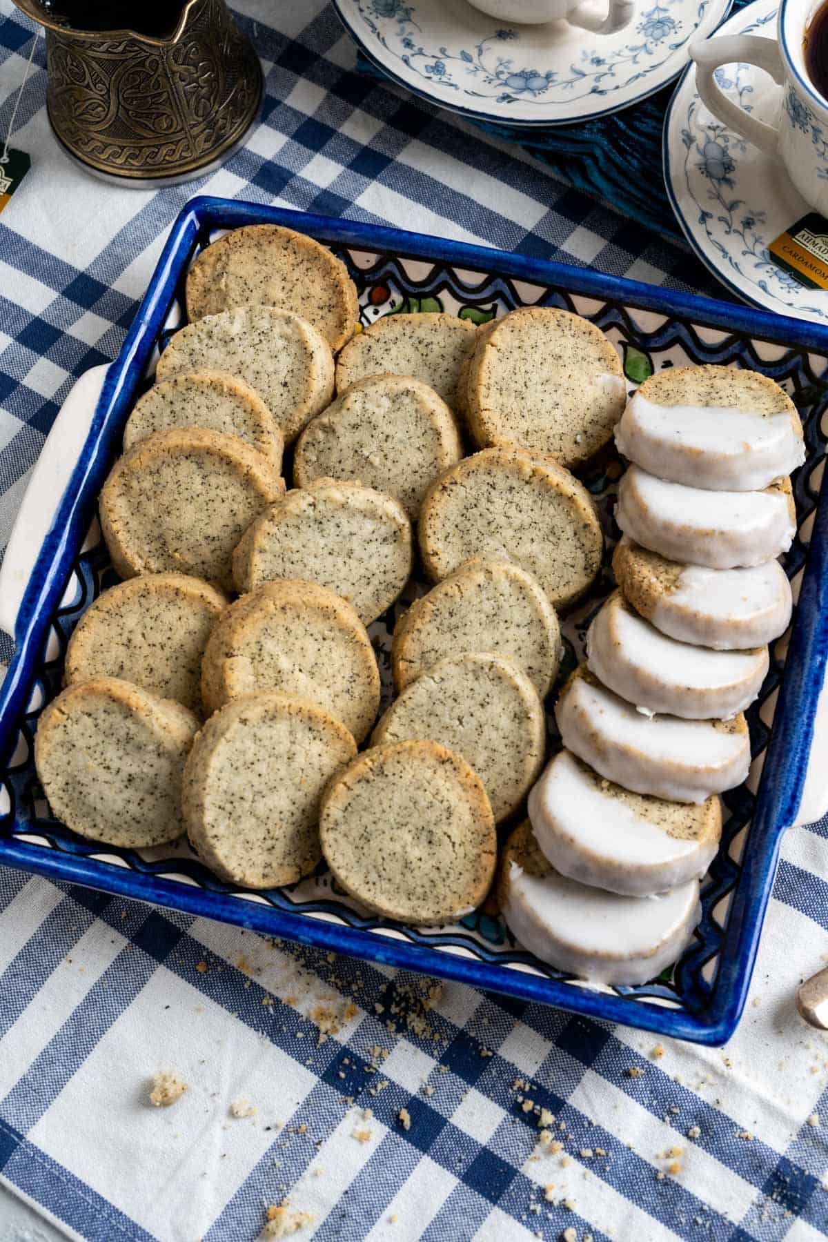 over the head shot of the cookie plate with crumbled earl grey shortbread cookies on the table cloth.