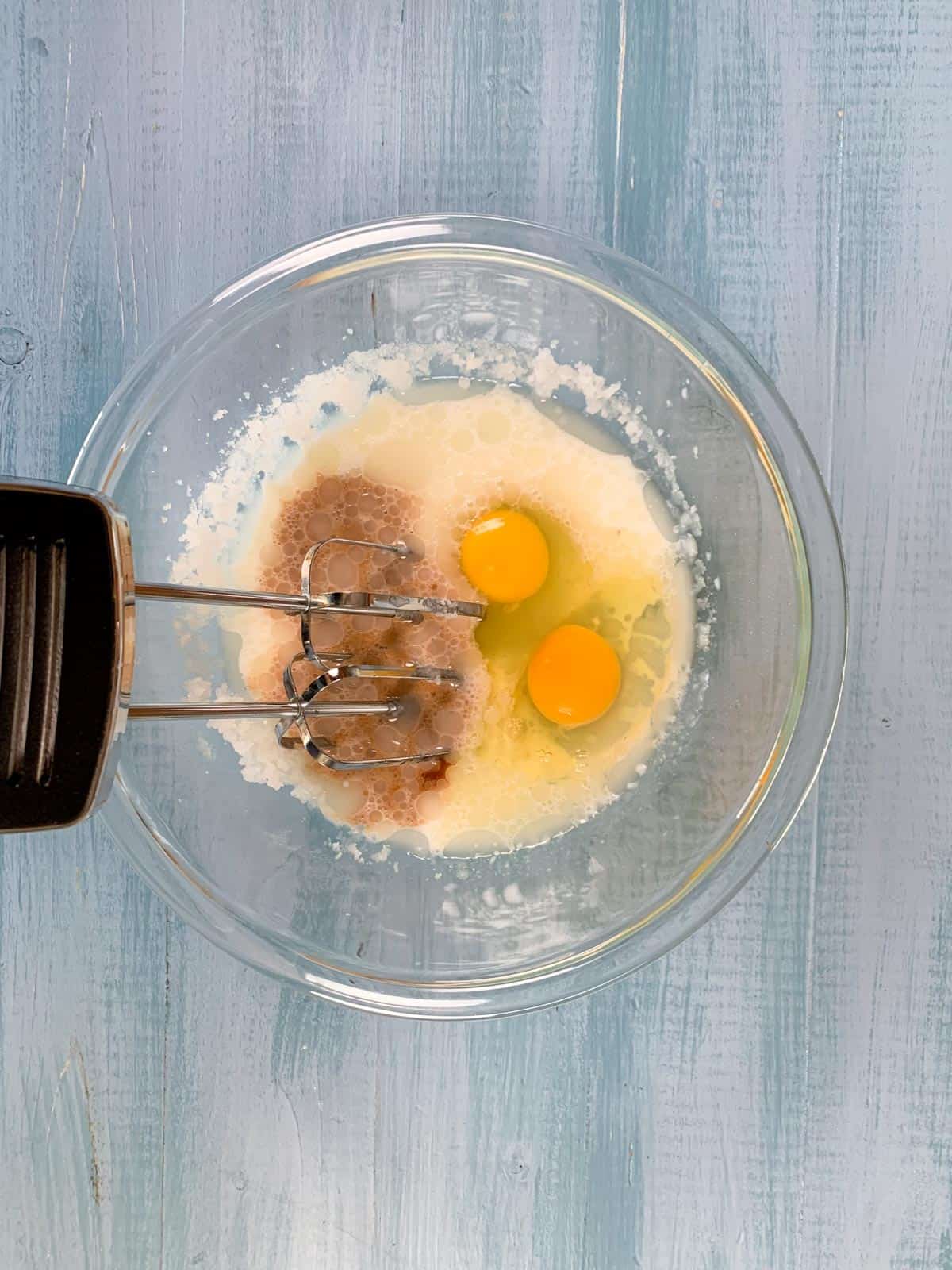 eggs and vanilla added to oil and sugar mixture for vanilla cupcakes.