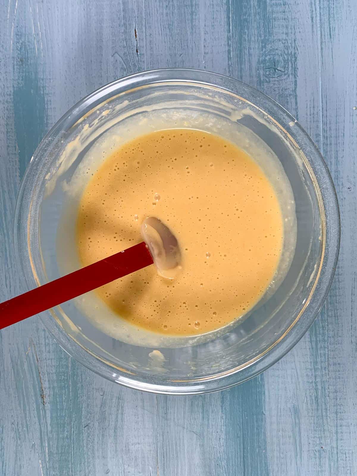 prepared batter for vanilla cupcakes with oil in a medium sized bowl.