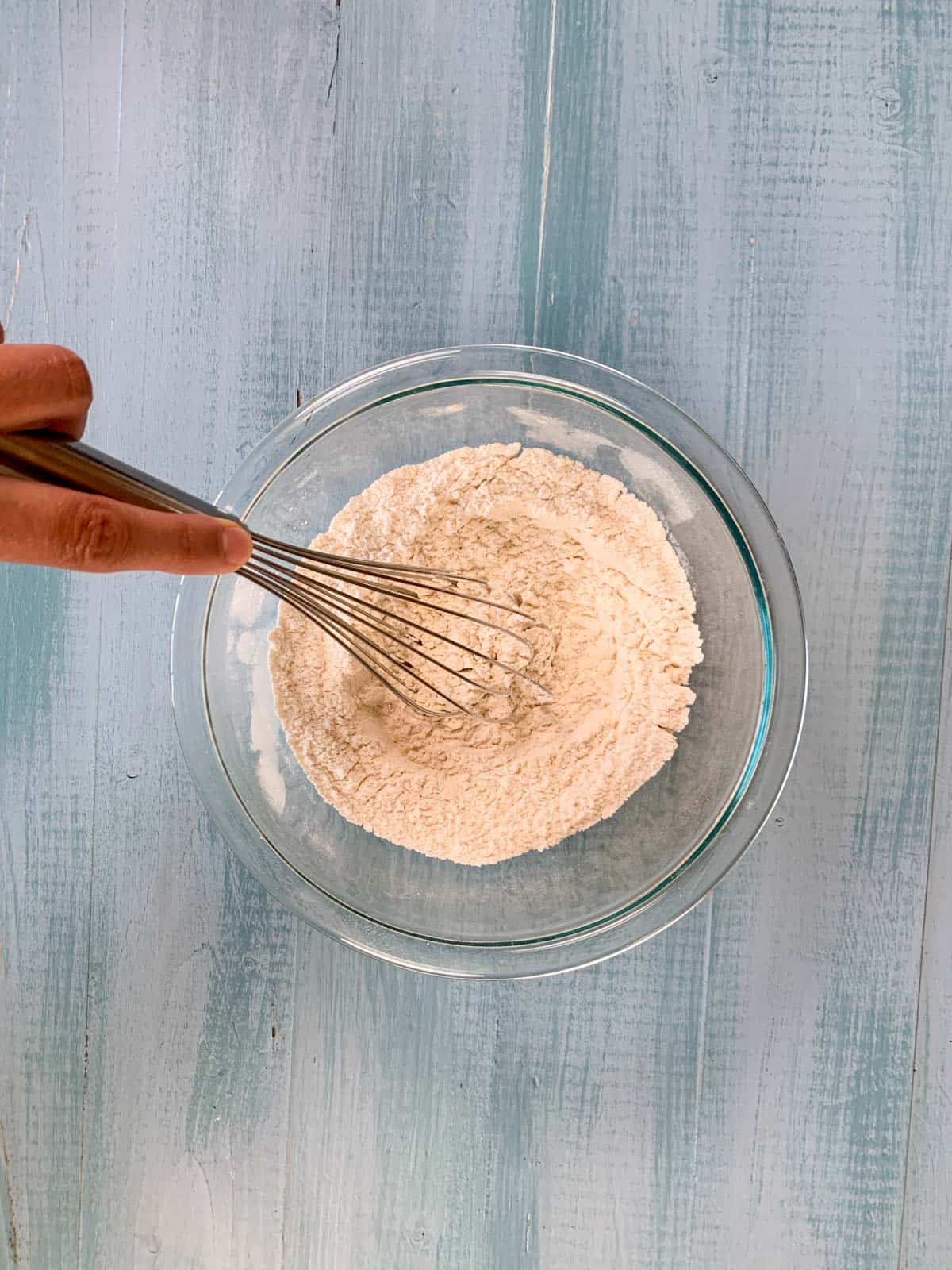 whisk all-purpose flour in a bowl for vanilla cupcakes.