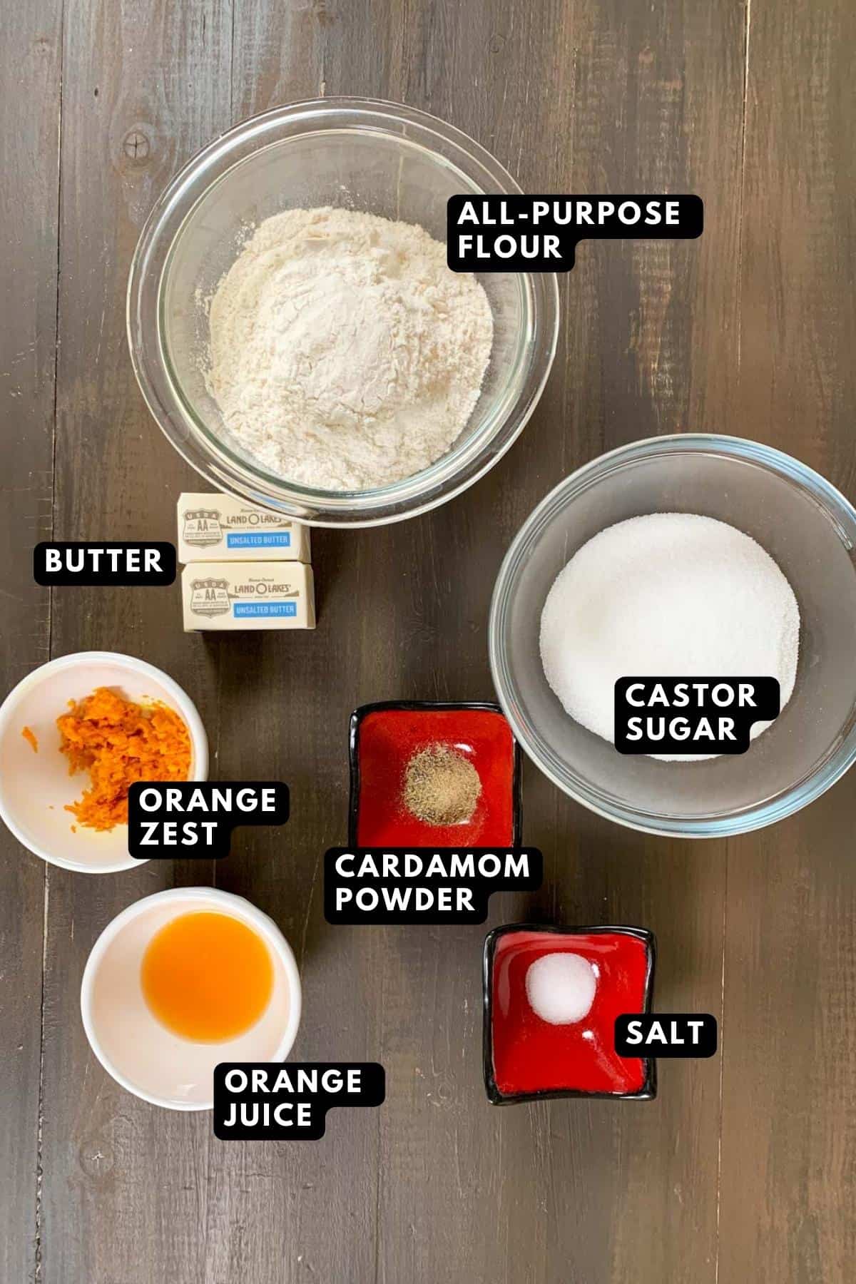 Orange cookies ingredients on a wooden plank.