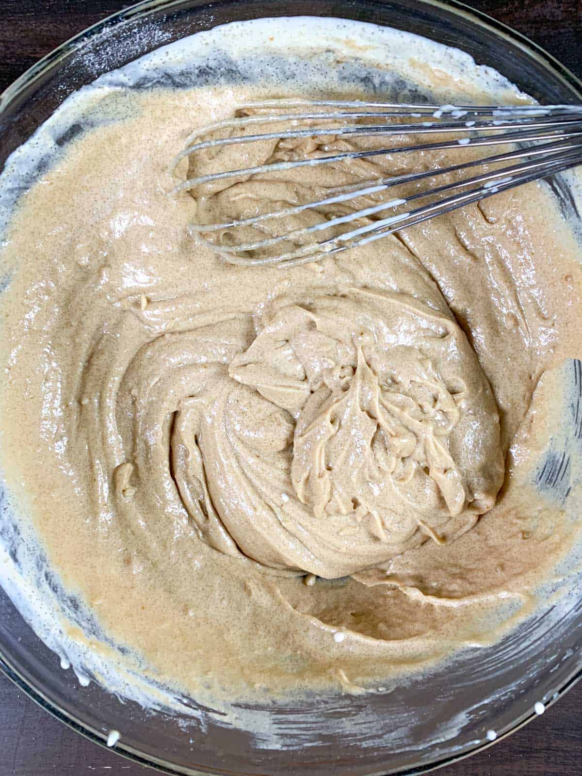 mixing the dry and wet ingredients for blueberry donuts.