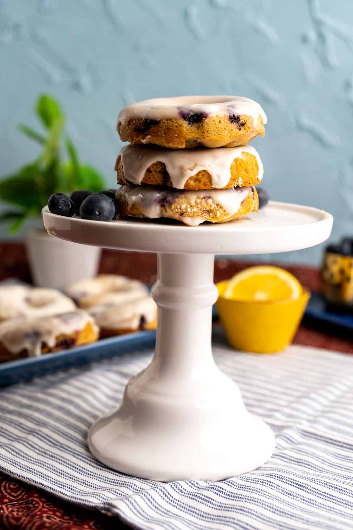 three blueberry donuts stacked on each other.