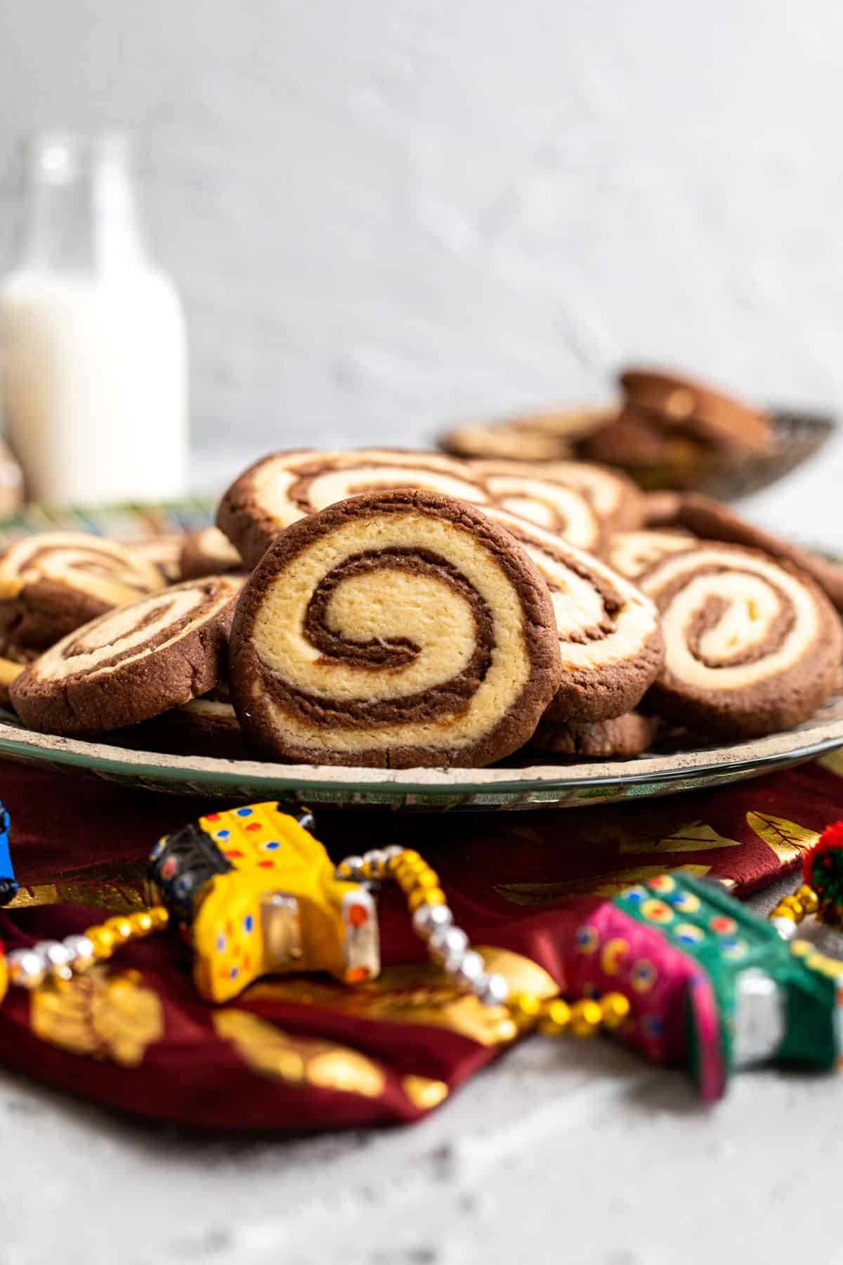 close up shot of the pinwheel cookies with milk bottle in the backdrop.