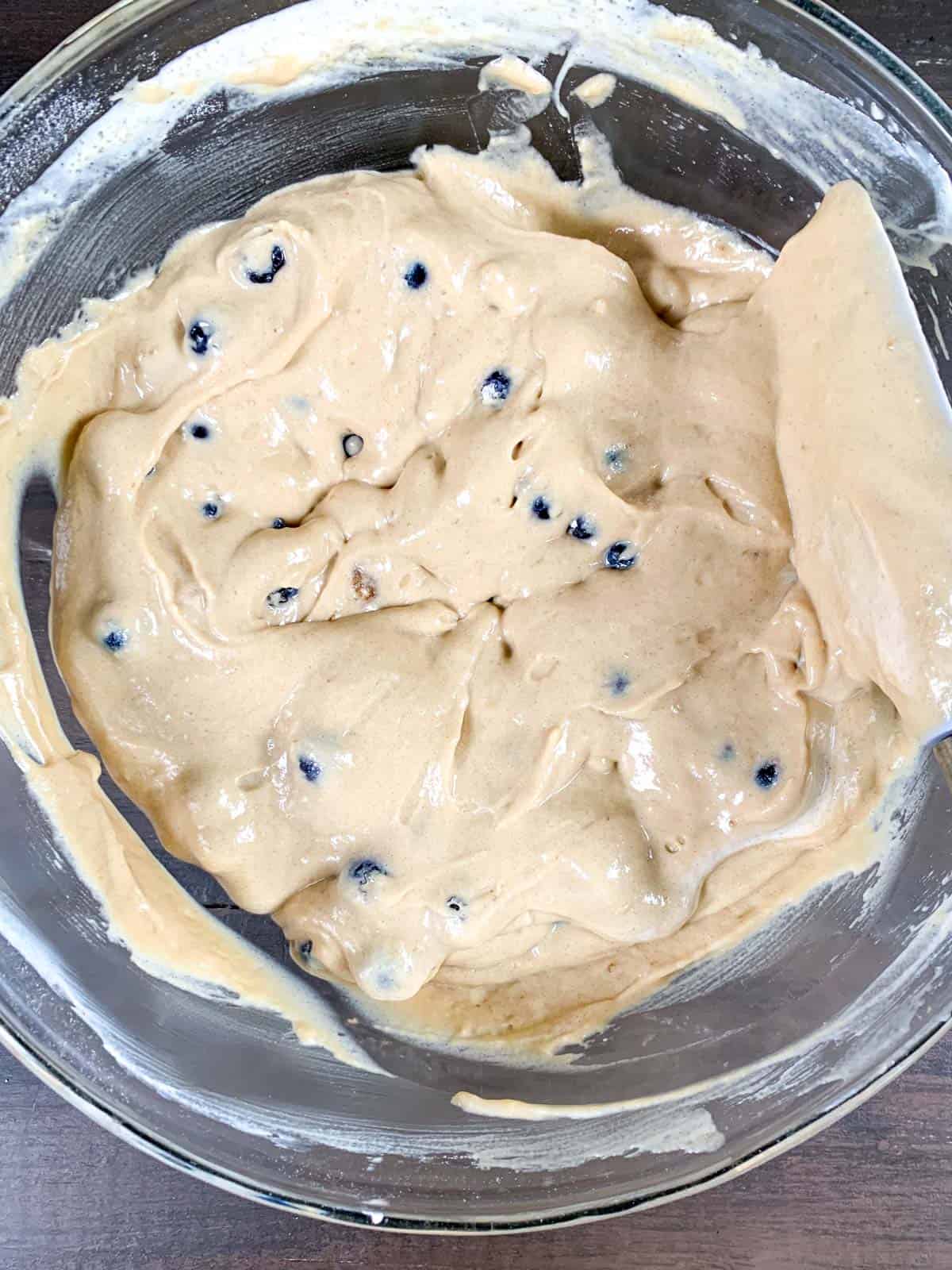 folding the blueberries in the donut batter with light hand.