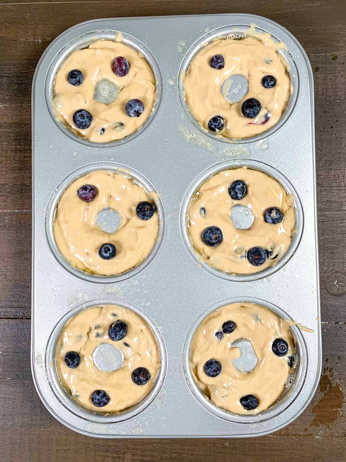 filled donut pan with the blueberry donuts batter.