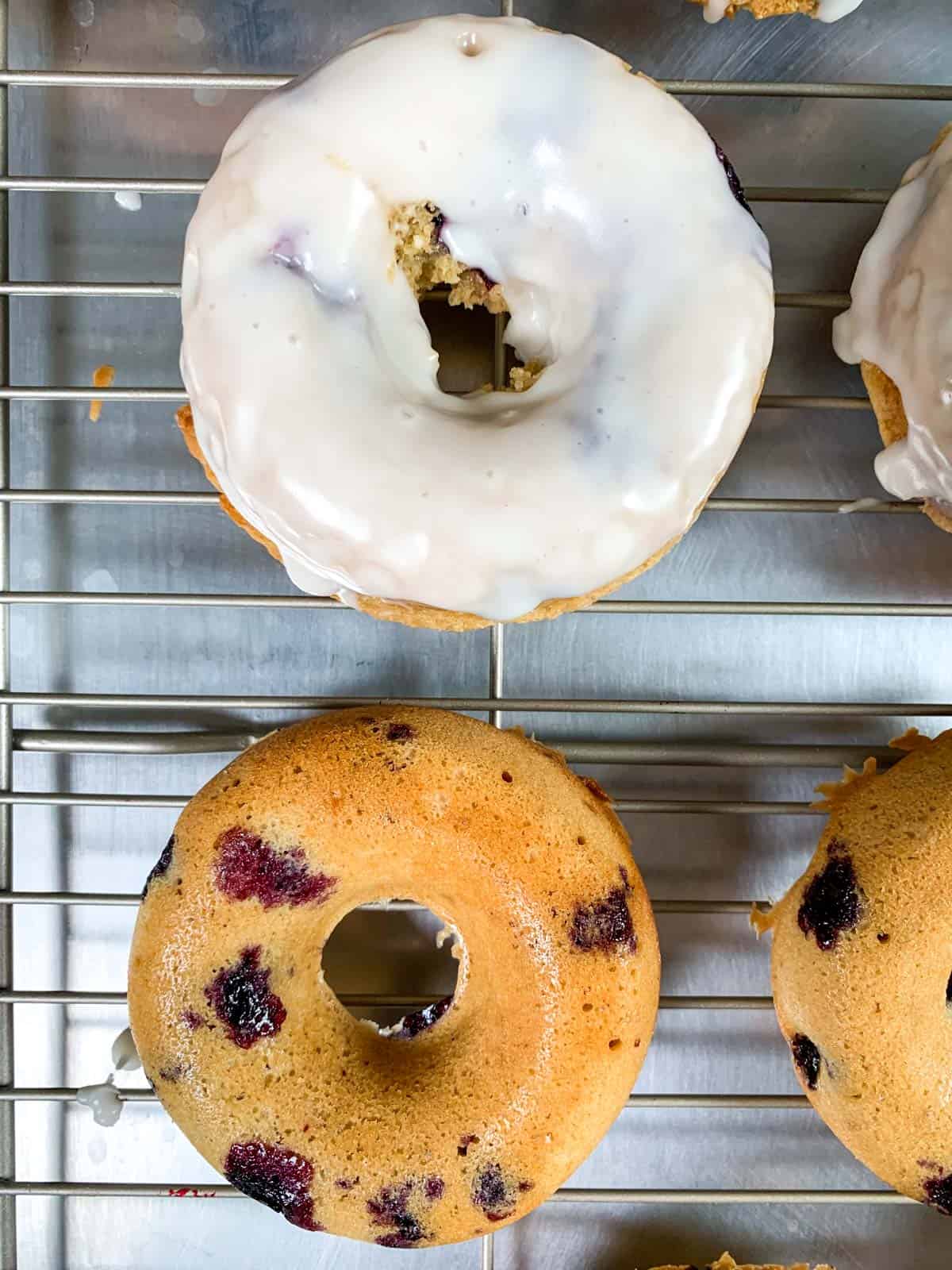 donuts with icing and without icing on a tray.