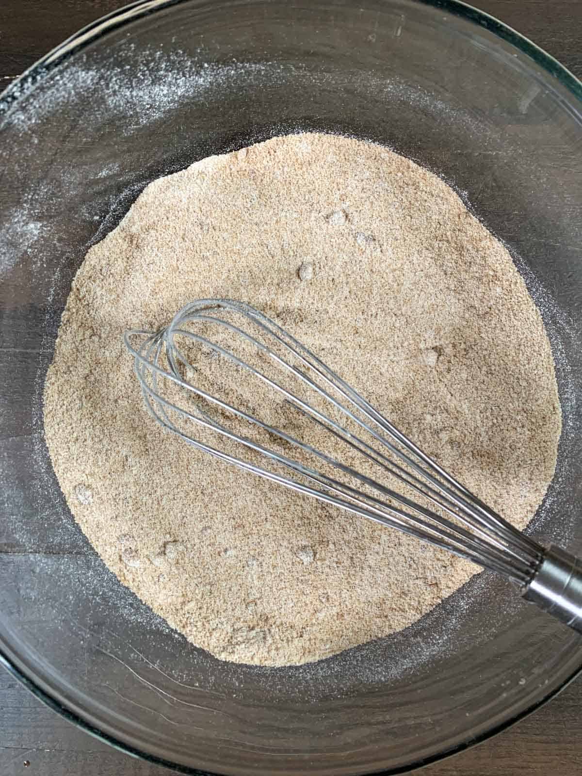 whisking the dry ingredients for donuts.