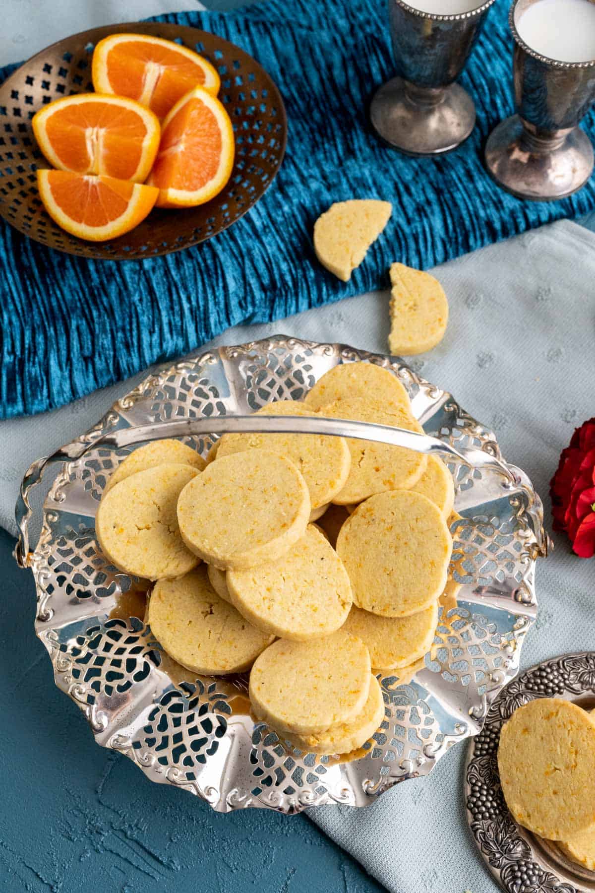 Shortbread cookies with orange in a fancy silver dish on the table.