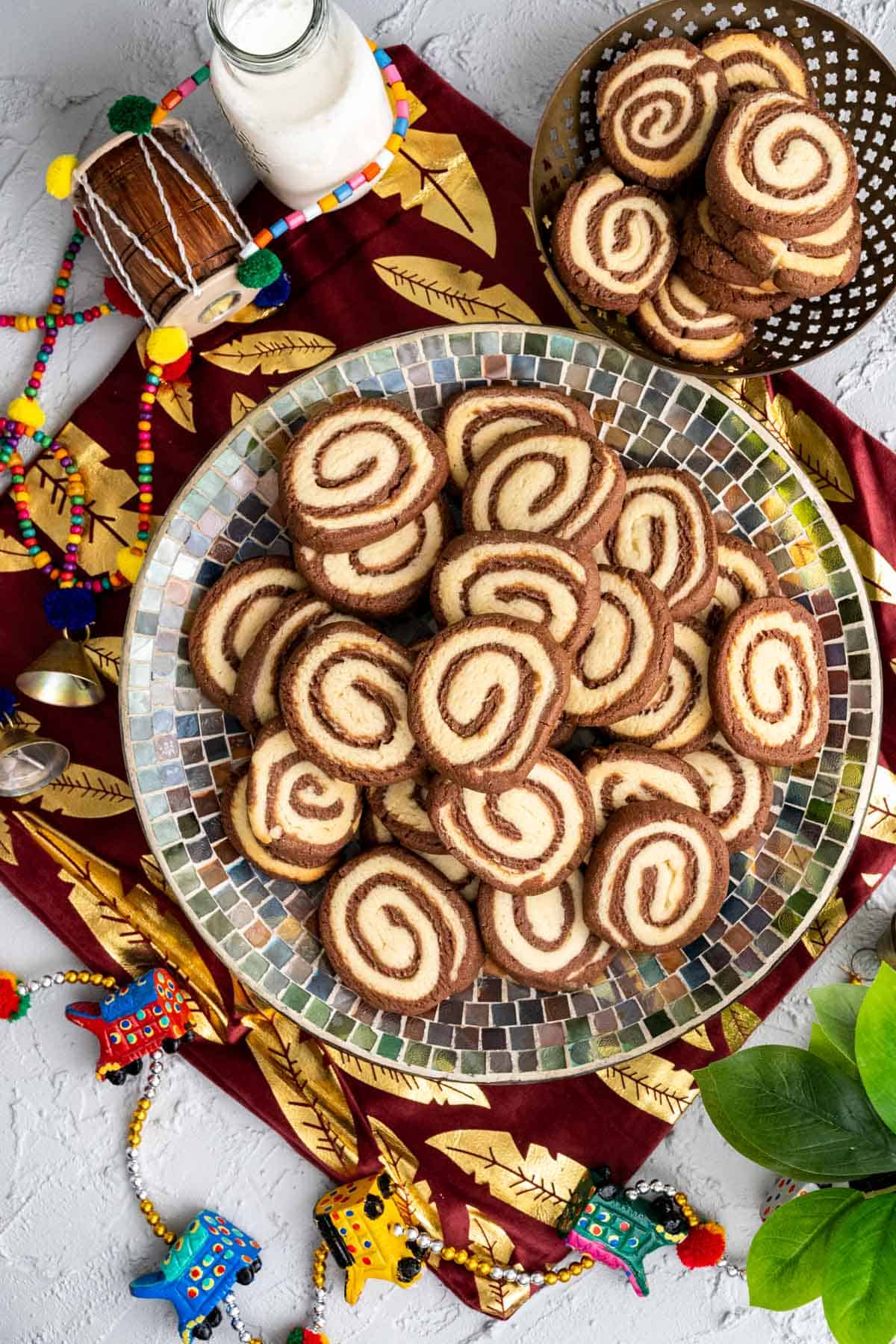 overhead shot of the pinwheel cookies stacked in a multi color plate. 