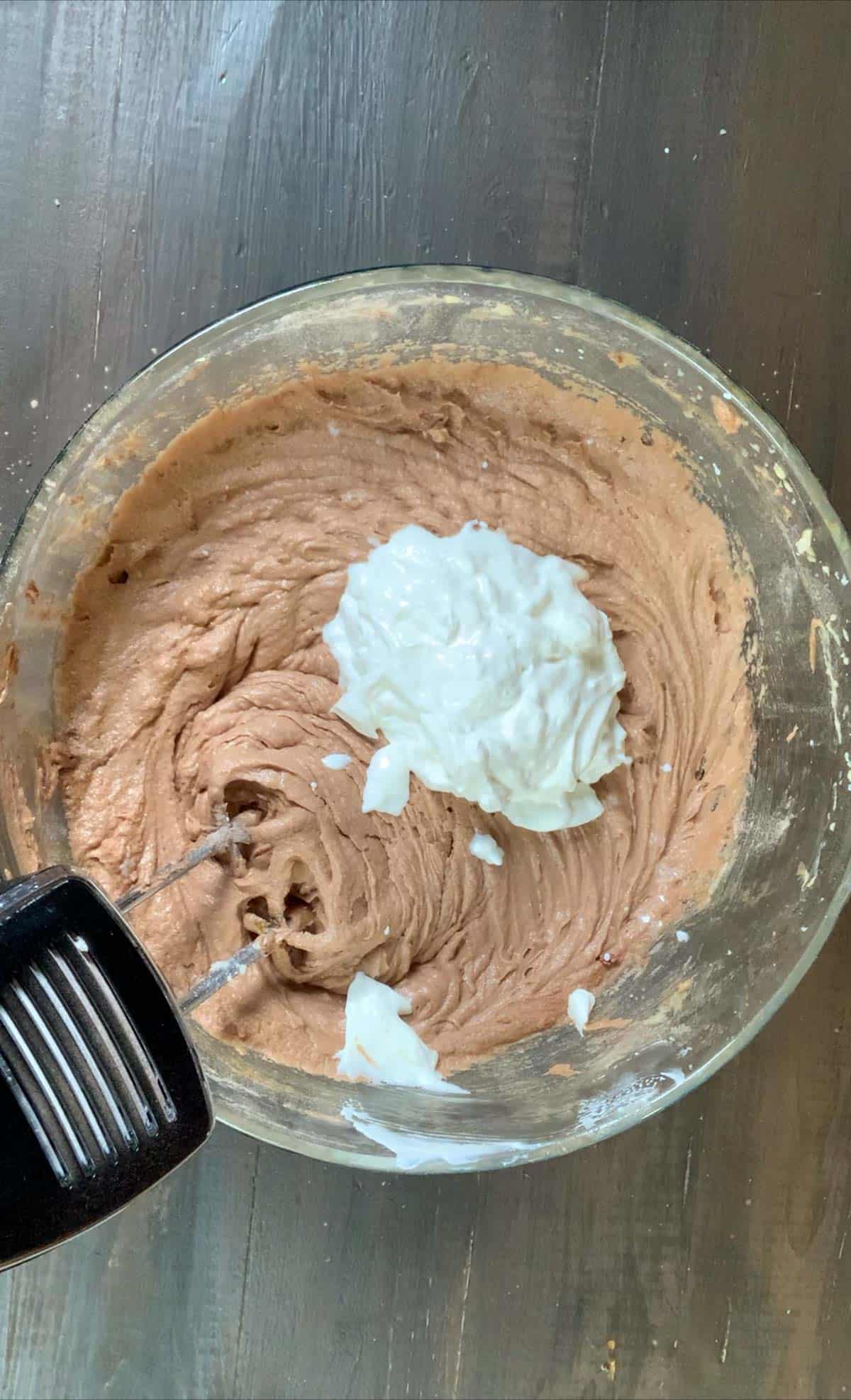 folding in the sour cream into the chocolate sour cream pound cake.