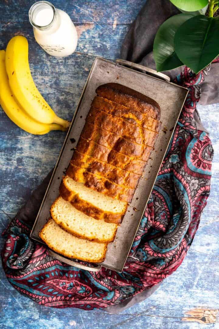 over the head shot of banana bread on blue table.