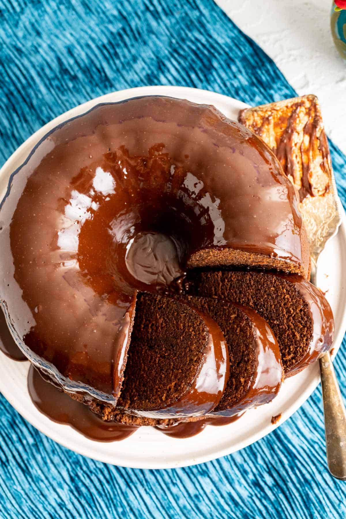 three slices of the chocolate sour cream pound cake on a white plate with golden spoon.