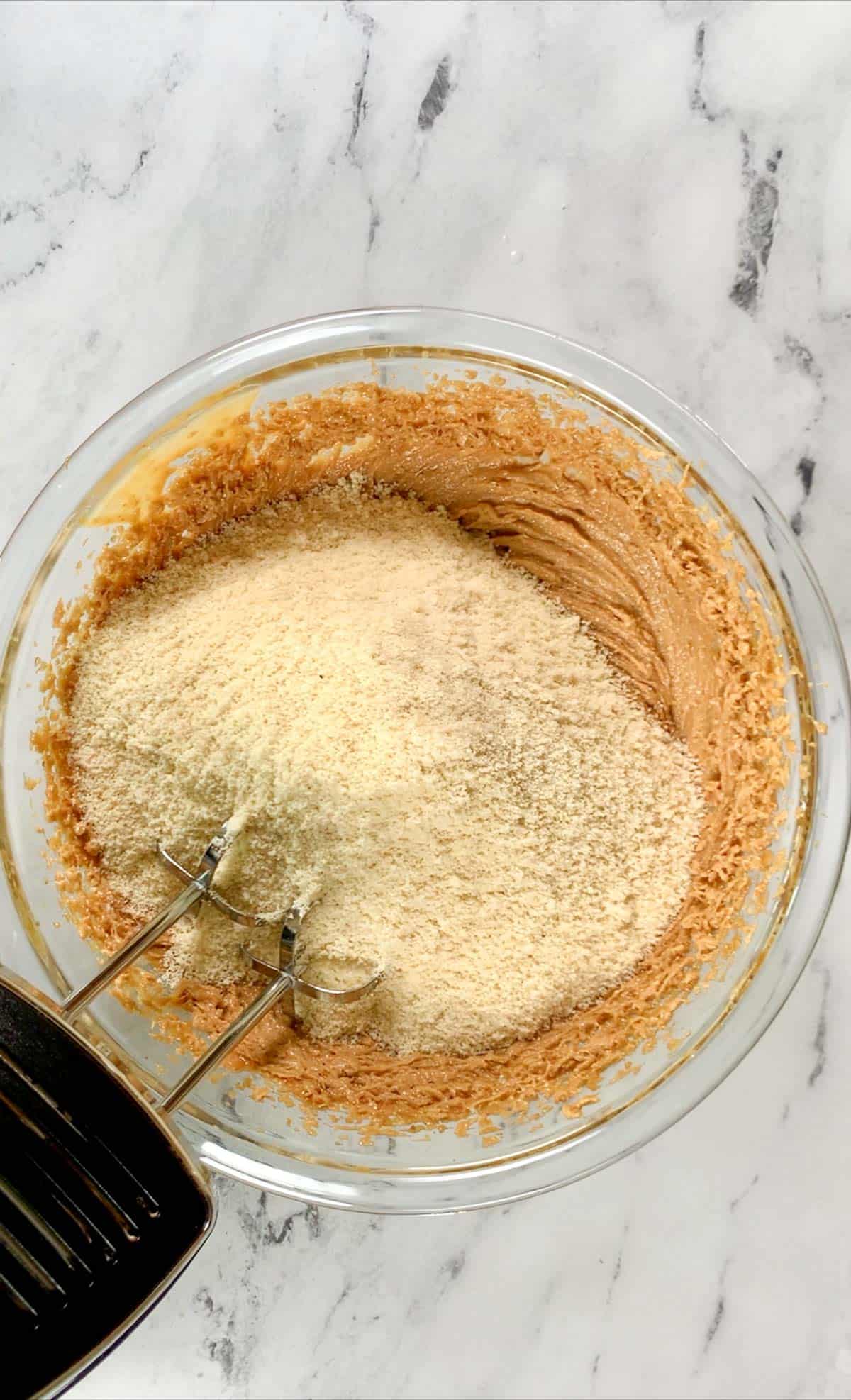 Almond flour added to the wet ingredients for cookies.