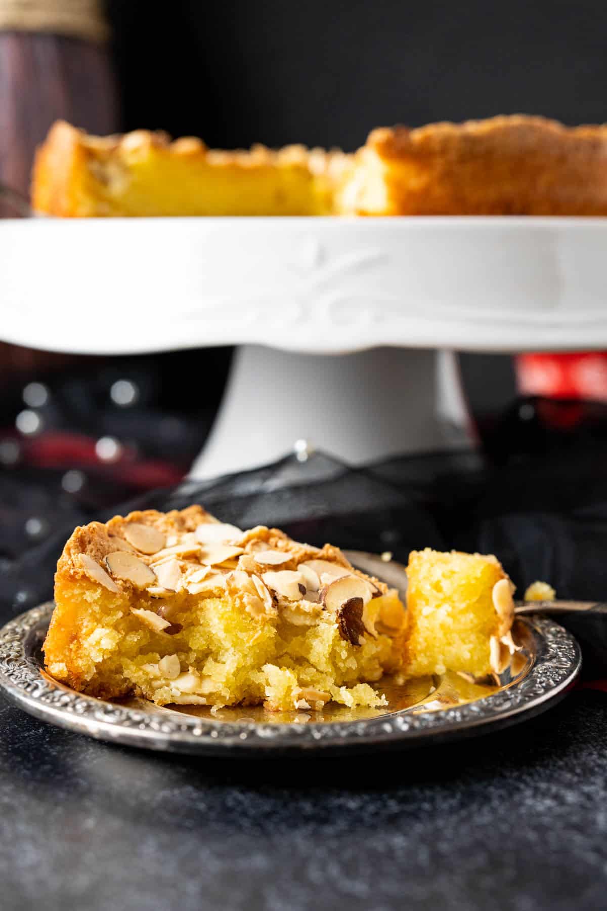 One slice of Italian cake showcasing the texture with almond slivers.