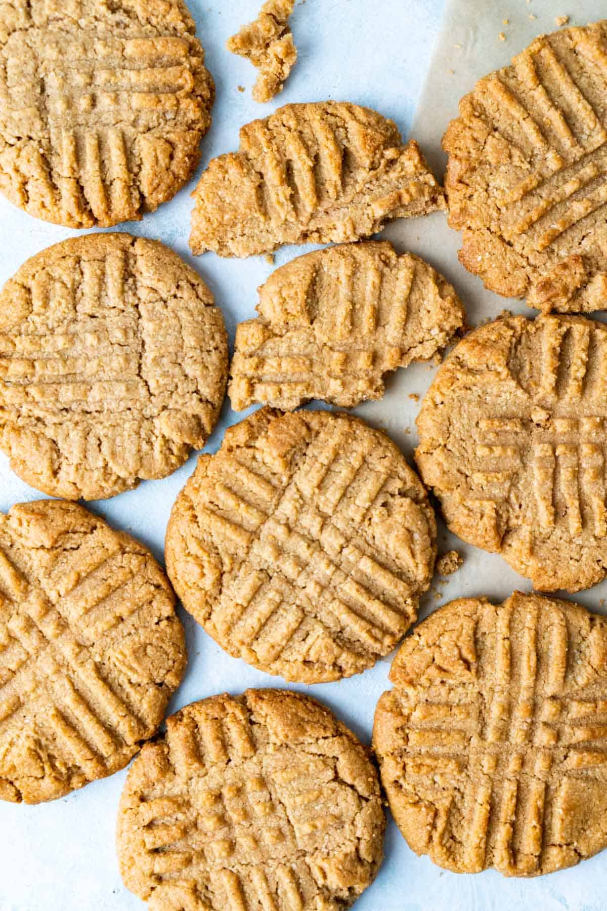 Almond flour cookies placed next to each other on a light blue surface.