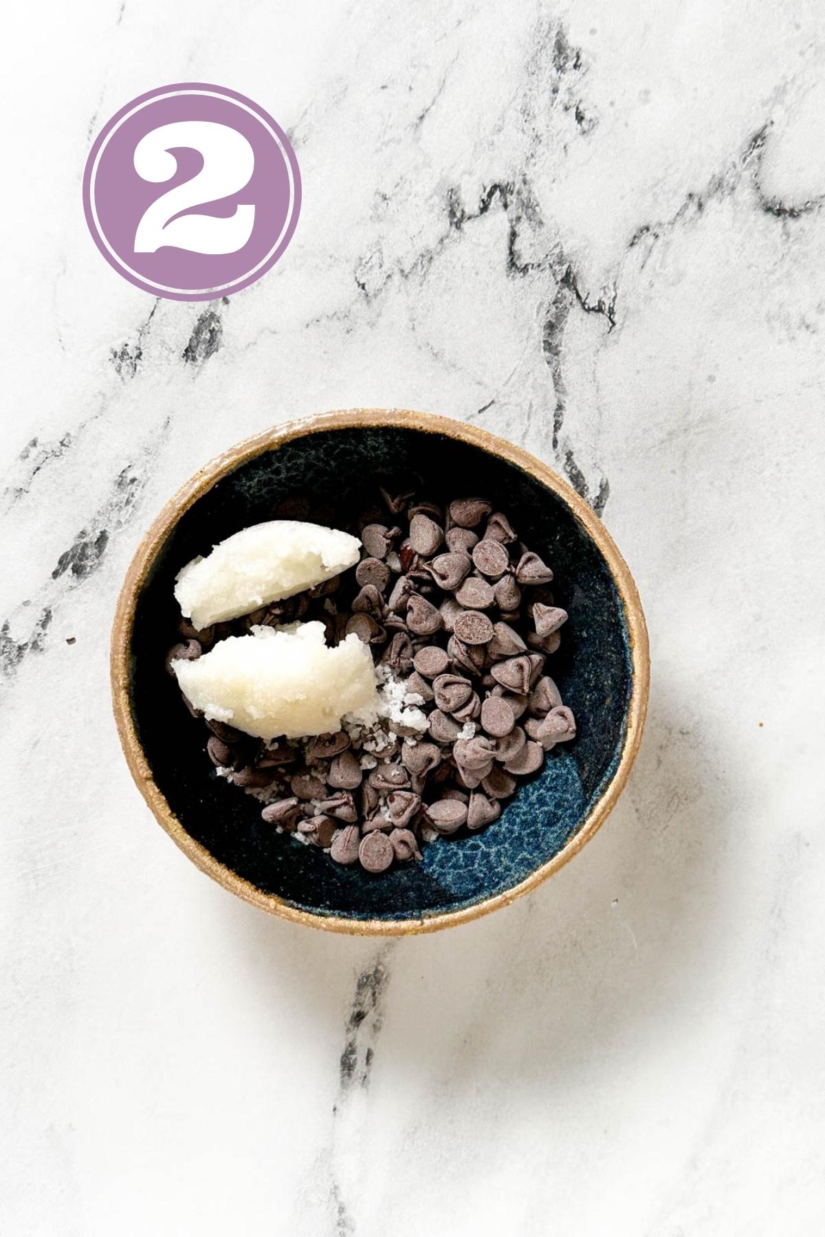 chocolate chips, coconut oil and salt in a bowl before melting in the microwave for chocolate covered pecans recipe.