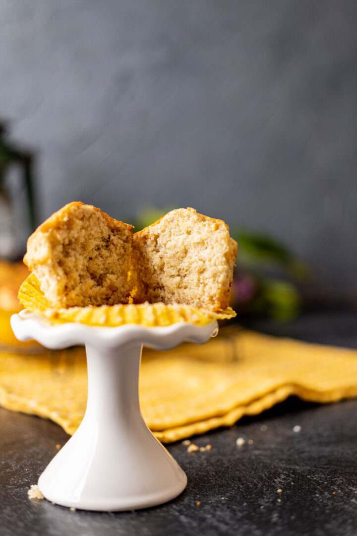 bisquick banana muffin cut in half on a white stand.