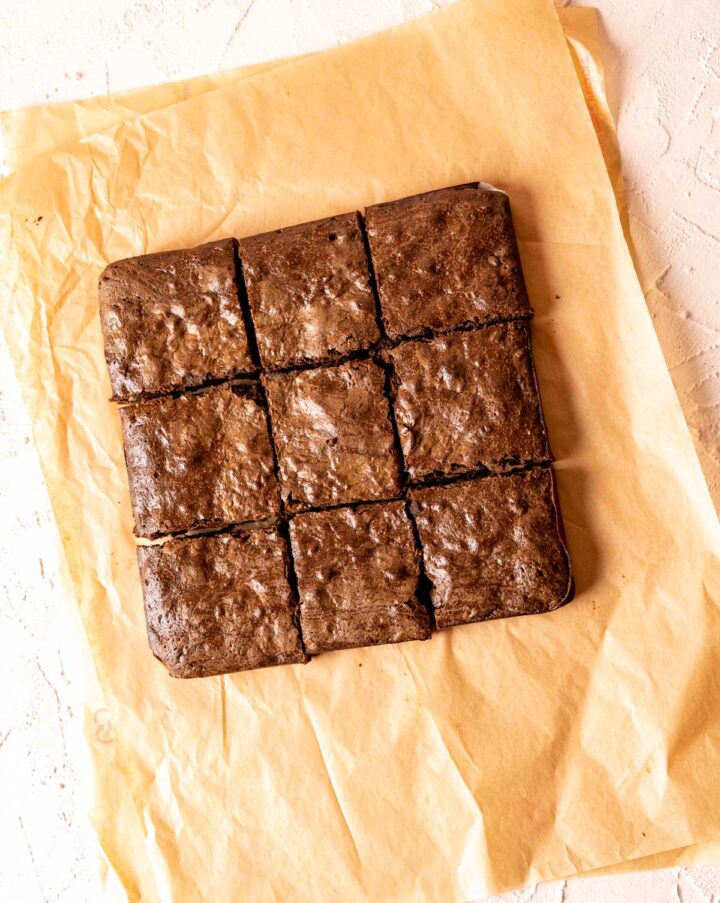 over the head shot of 9 pieces of brownies put together on brown paper.