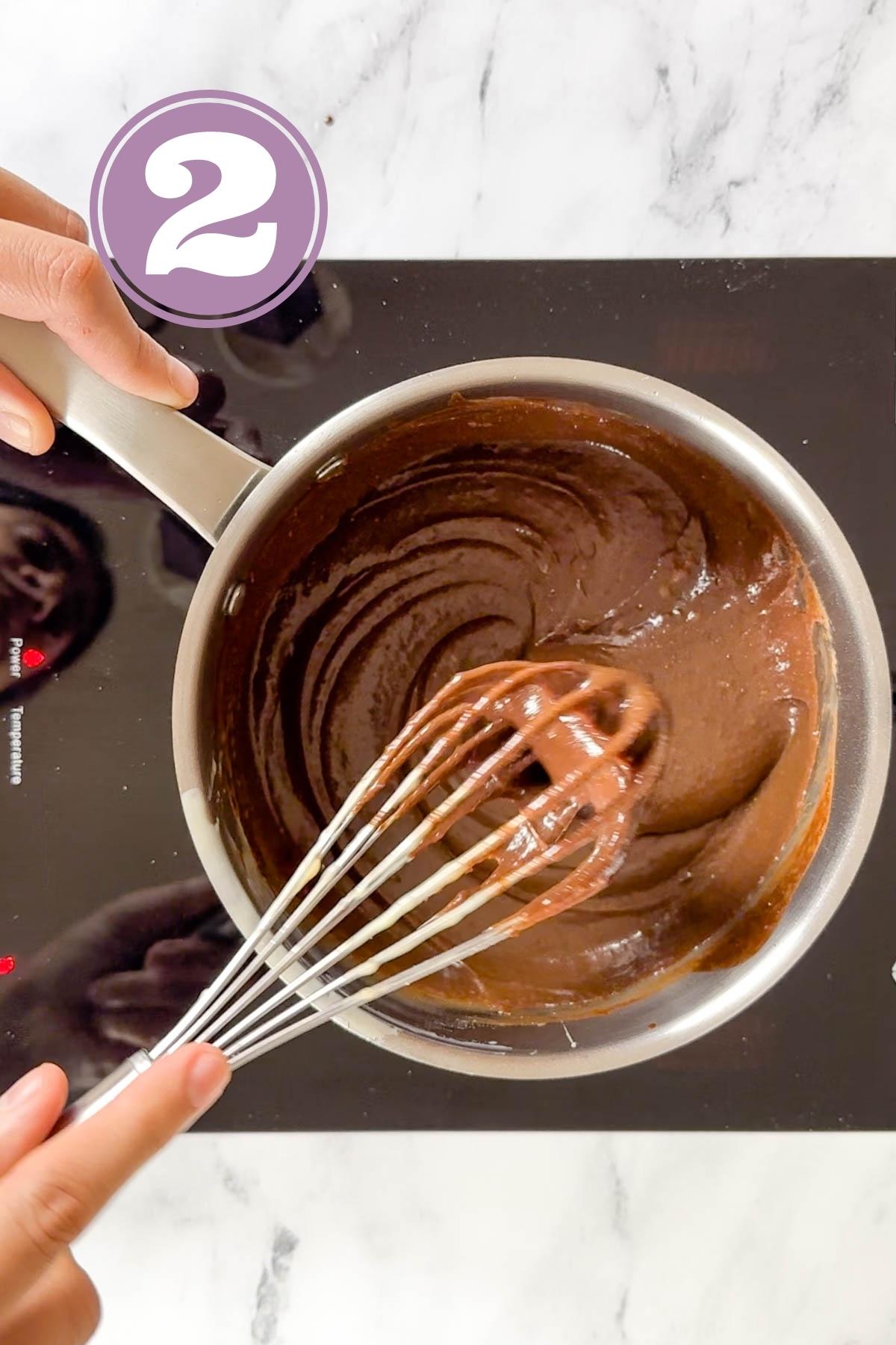 Melting the chocolate and butter using a whisk.