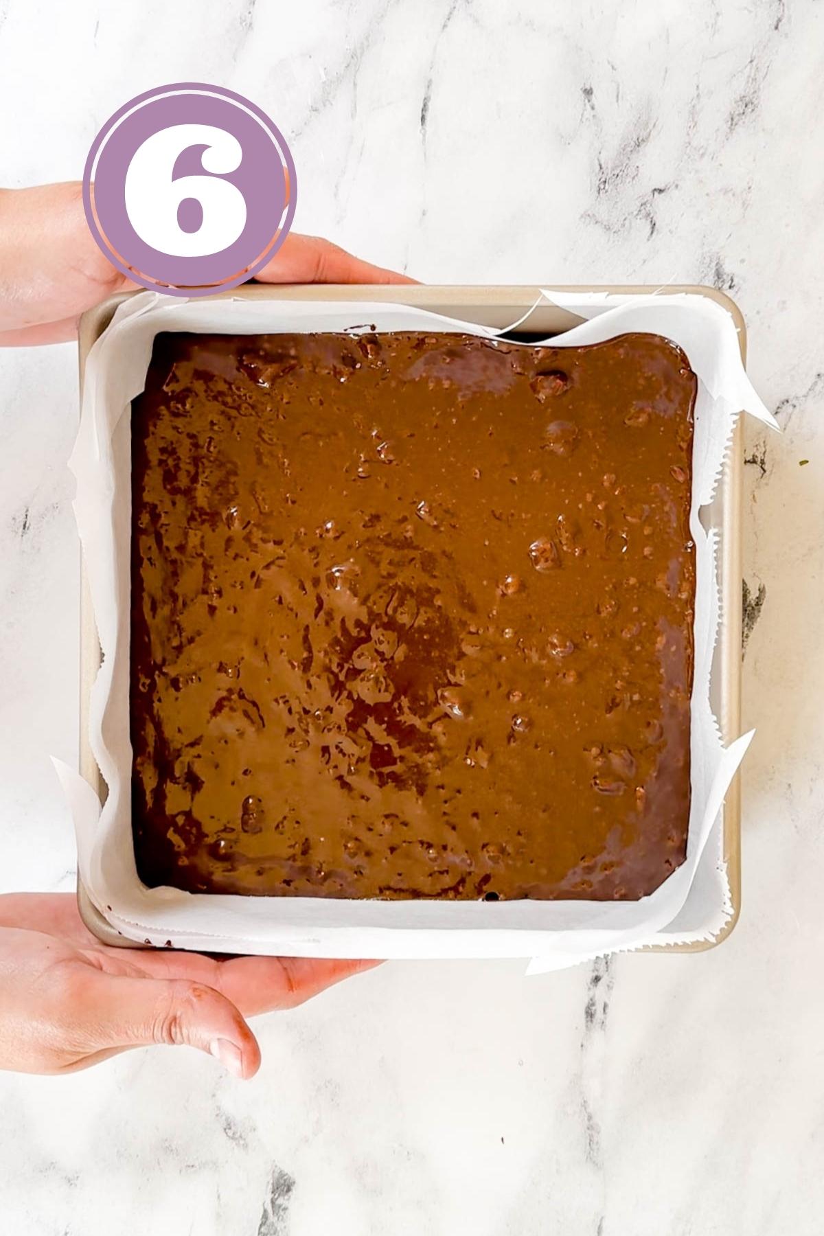 Brownies batter in the square pan ready to go in the oven.