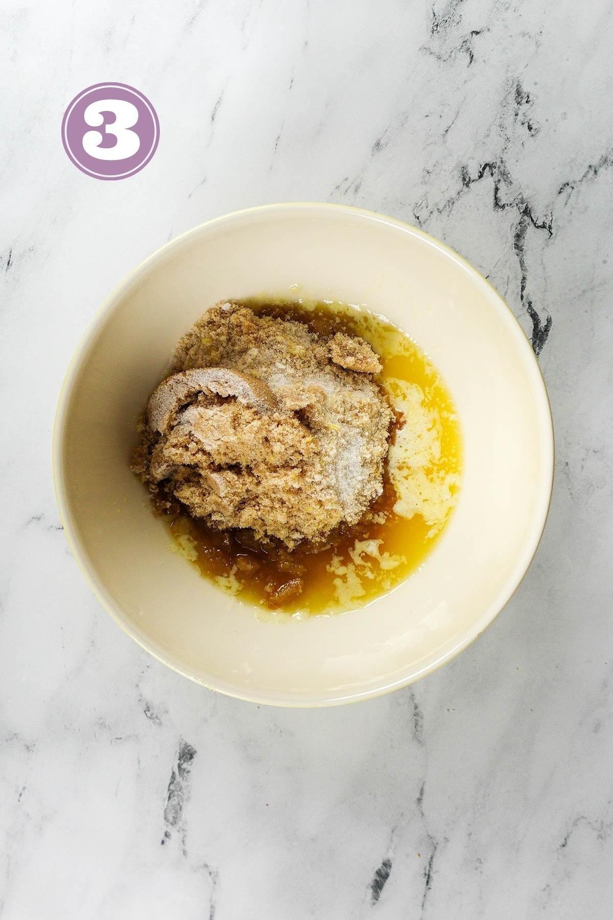 Combined wet ingredients including butter, sugar and lemon zest in a medium sized bowl.