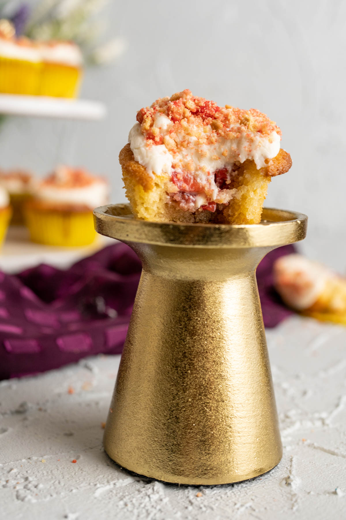 Strawberry crunch cupcake cut in half showing the texture of the cupcake.