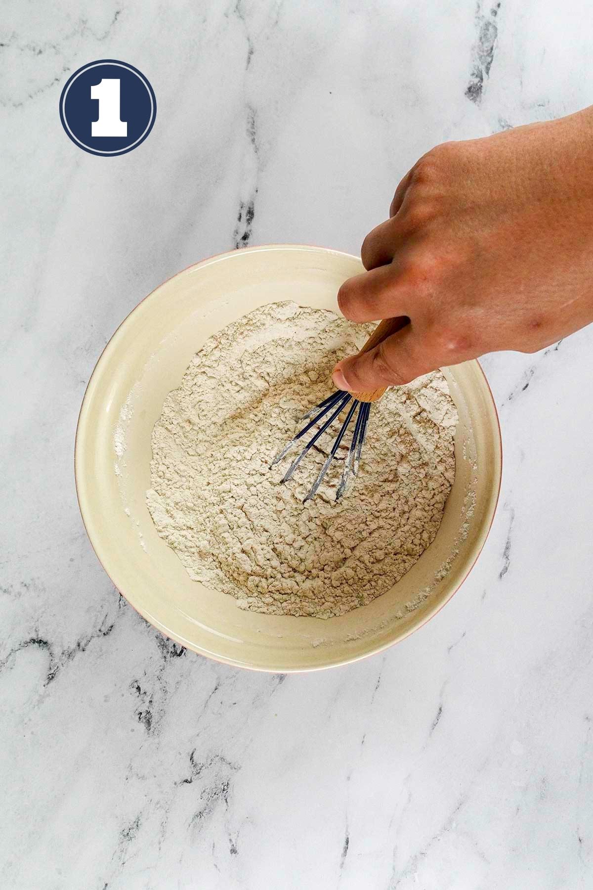 Dry ingredients in a medium sized bowl with a whisk.