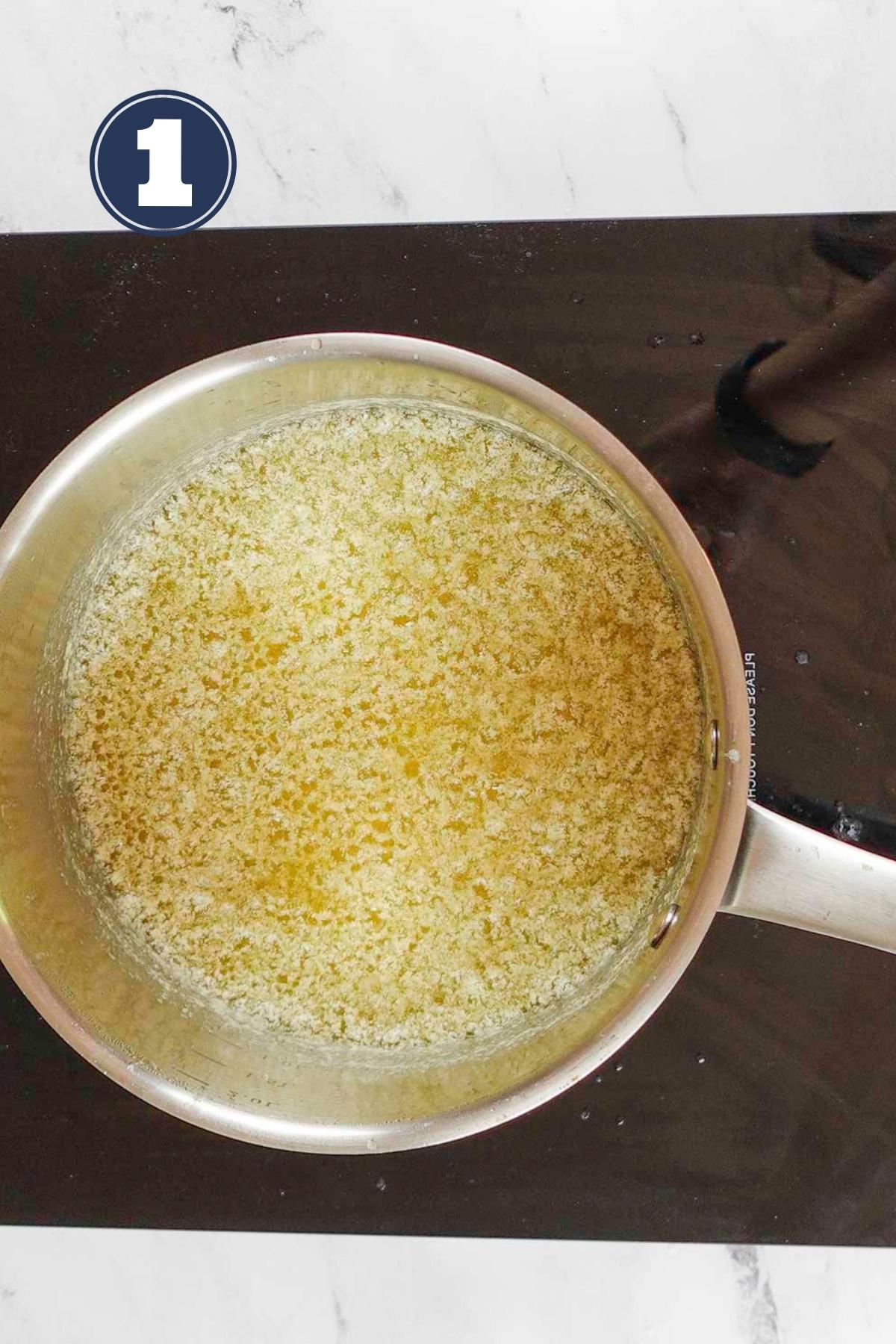 melting the butter in a saucepan on the stove.