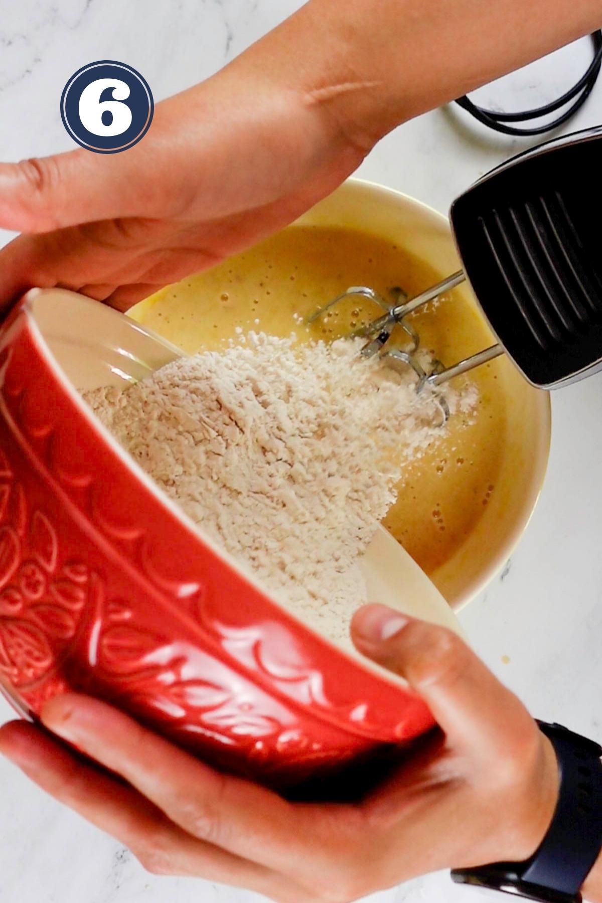 Adding the flour in the batter of banana bread.