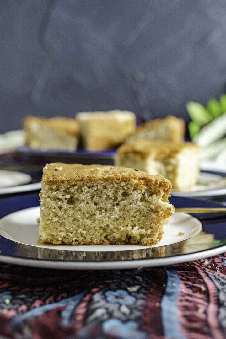 close shot of ghee cake piece showcasing the texture with moist crumb.