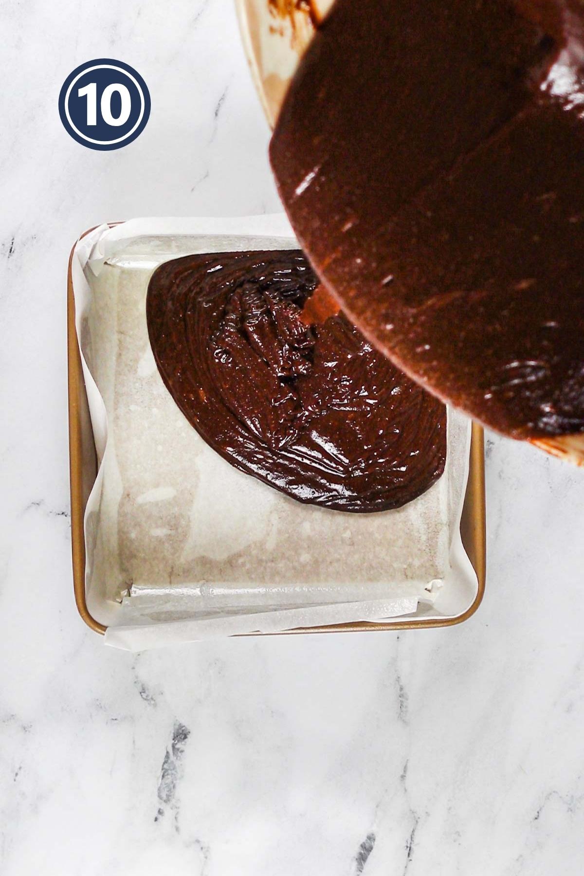 Pouring the brownie batter in the 8-inch cake pan.