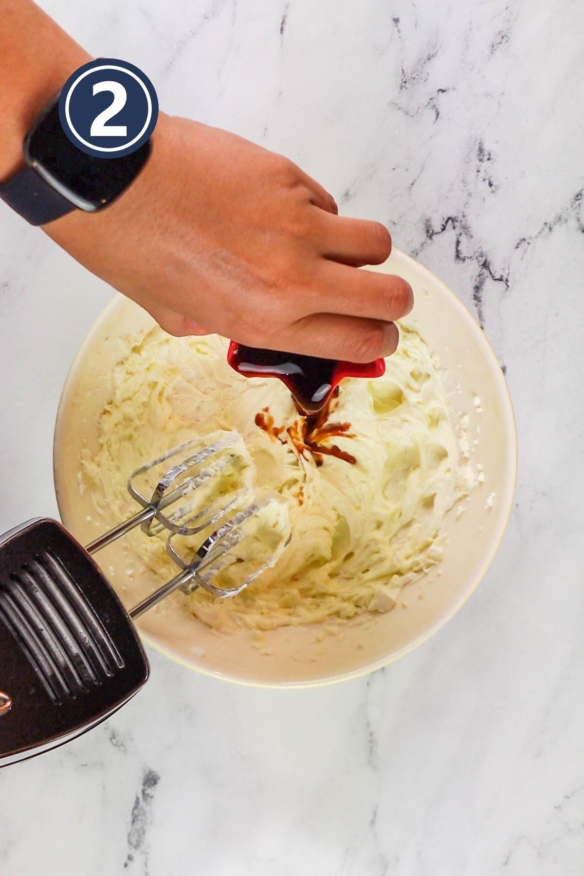 Adding vanilla extract in the beaten butter and cream cheese.