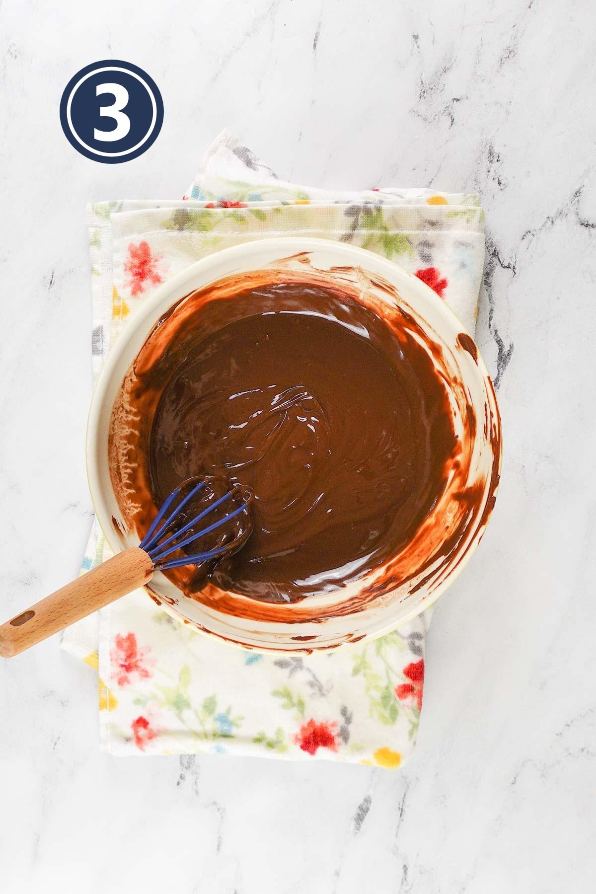 Melted chocolate and butter in a bowl out of the microwave.