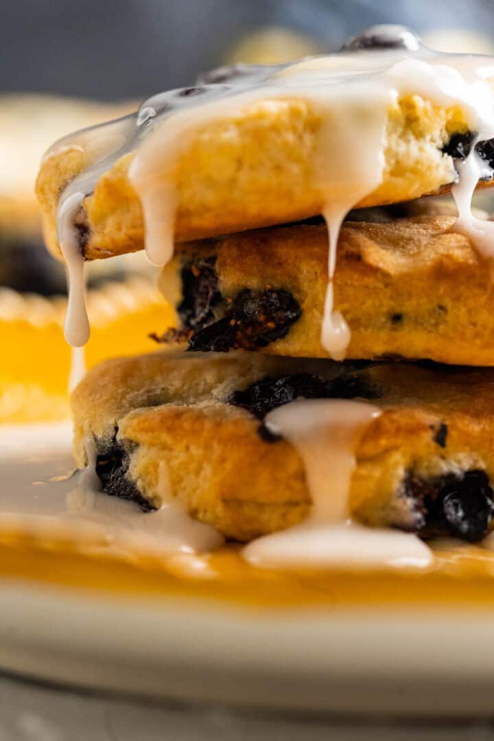 close shot of icing dripping off the biscuits.