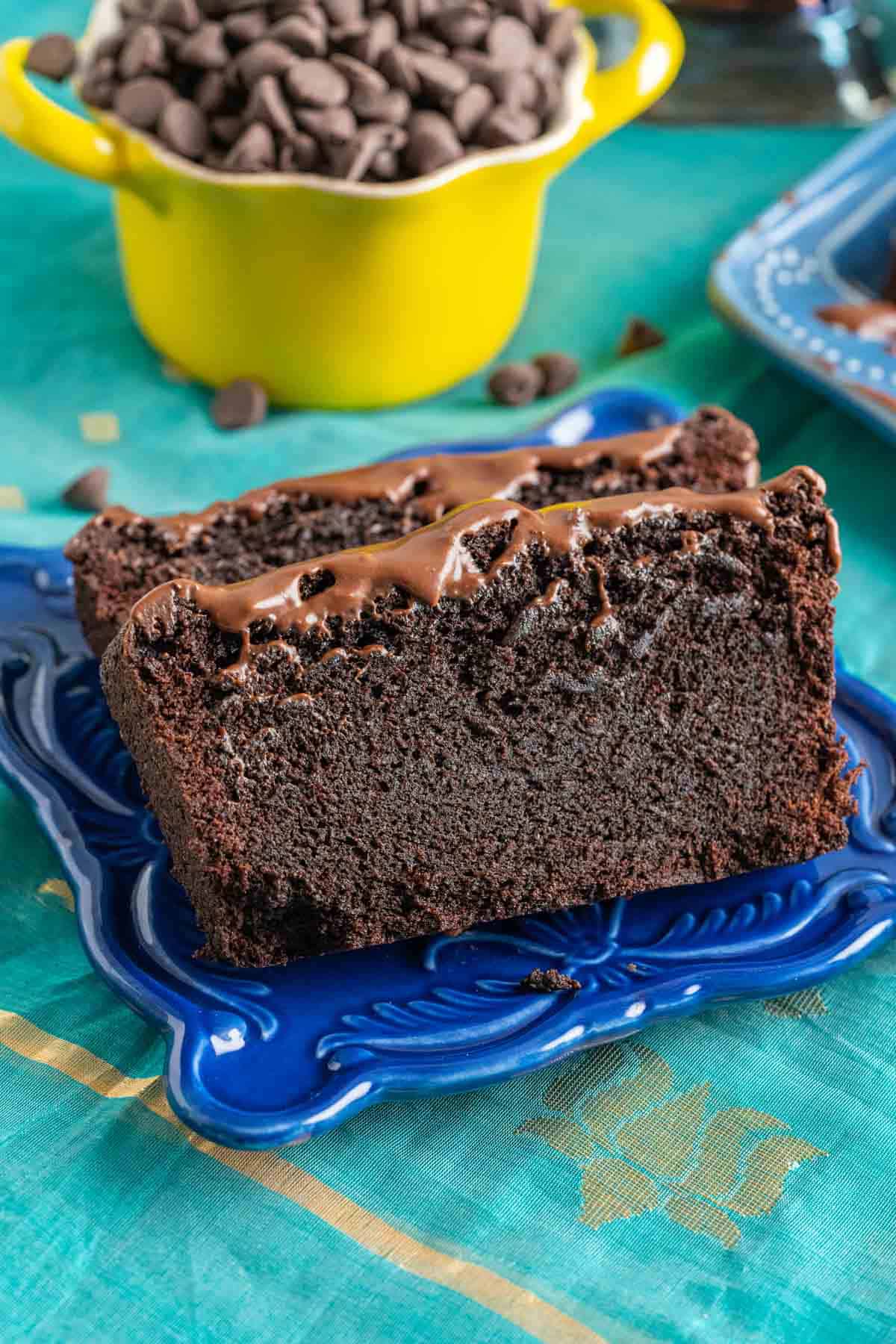 Two slices of chocolate quick bread served in a small blue plate.