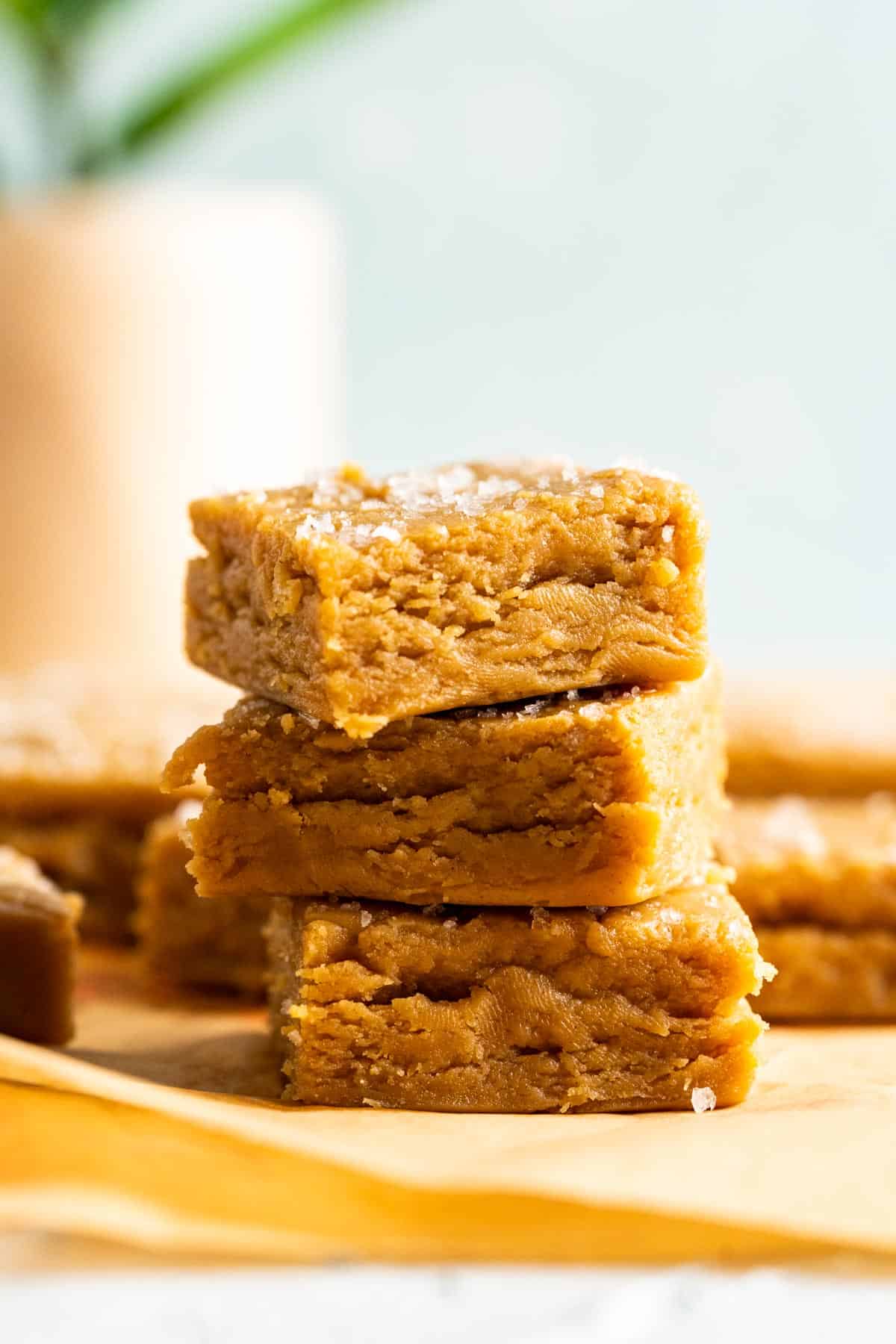 Three Peanut Butter Fudge pieces sitting on each other showcasing the texture.