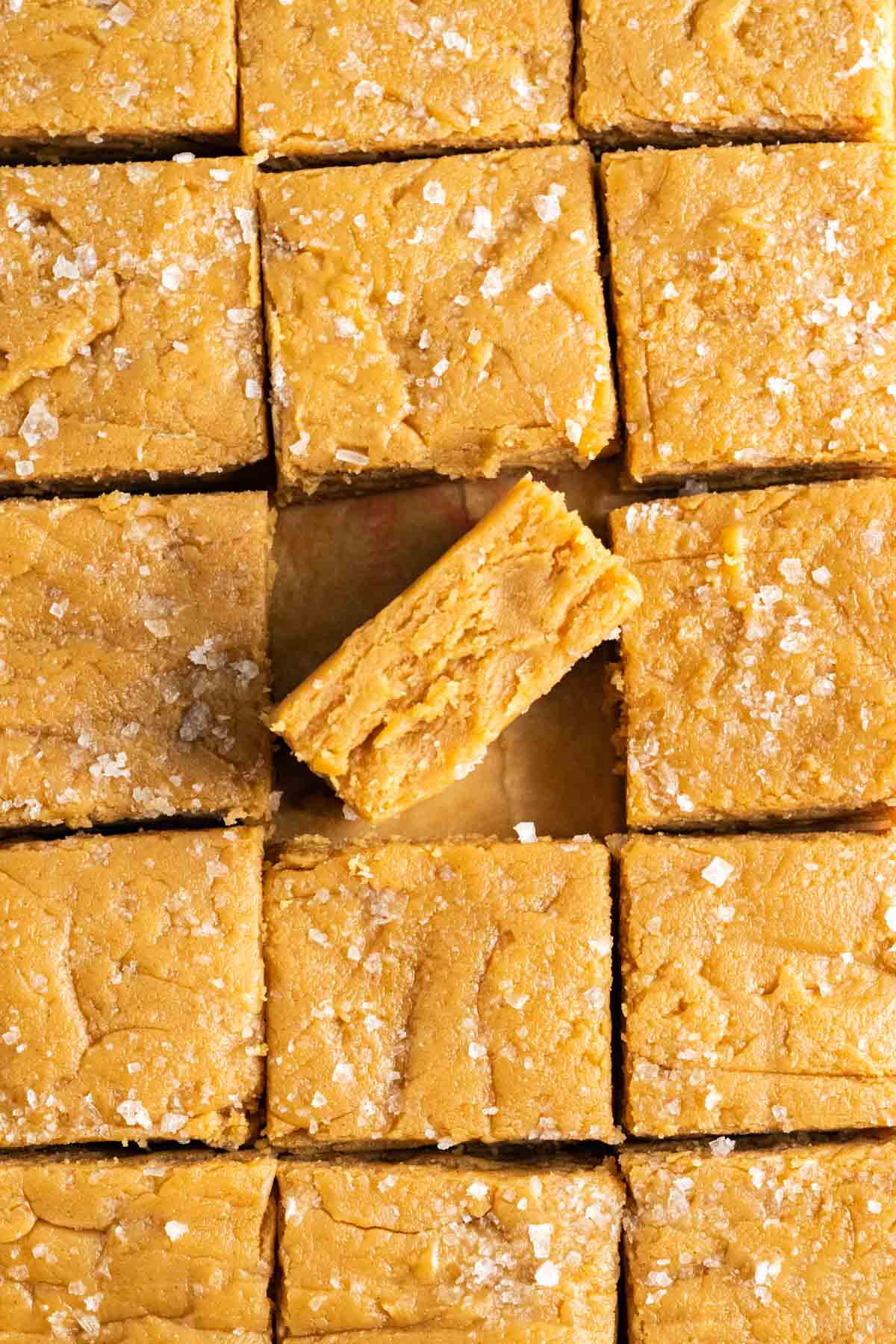 2-ingredient Peanut Butter Fudge piece standing diagonally in the pan along with other fudge pieces.