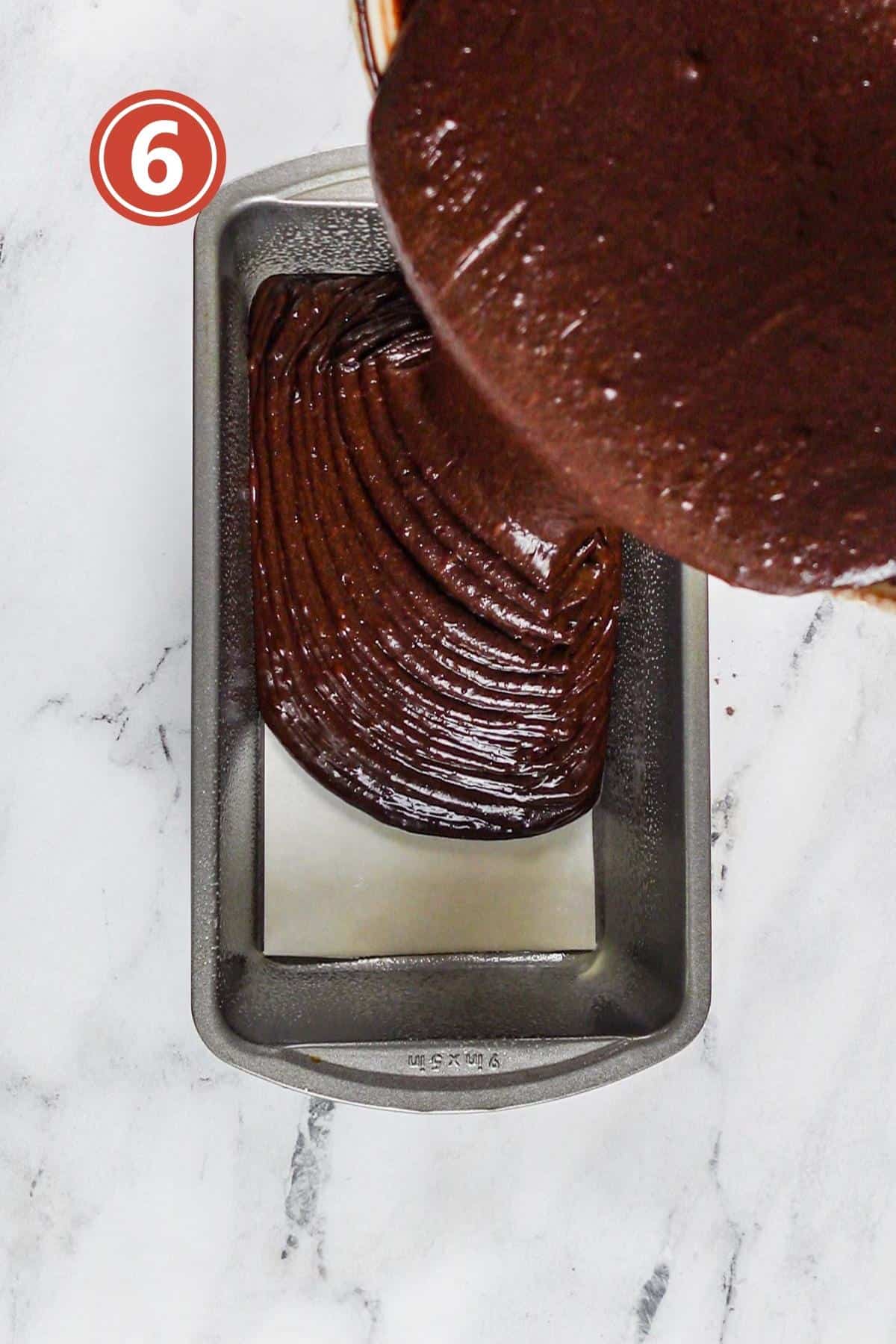 Pouring the cake batter into the prepared cake pan.