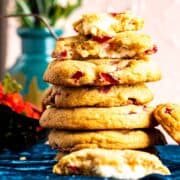 many strawberry cheesecake cookies stacked upon each other.