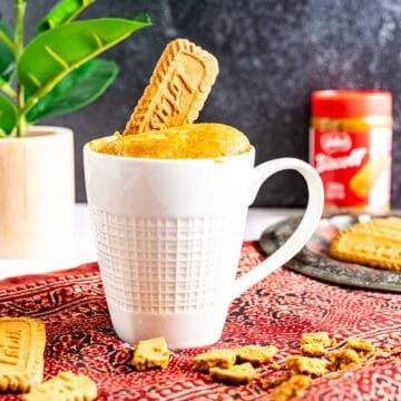 biscoff mug cake with biscoff biscuits around.